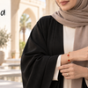 Woman in a neutral open-front abaya wearing delicate Yumeira 18k gold plated jewelry in the UAE